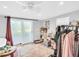 Bedroom with white ceiling fan, frosted glass slider doors and neutral walls at 4915 South Rd, New Port Richey, FL 34652
