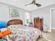 Bedroom with natural light, ceiling fan, and wooden dresser at 4915 South Rd, New Port Richey, FL 34652