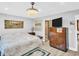 Bedroom with a patterned bedspread, ceiling fan and wood flooring at 4915 South Rd, New Port Richey, FL 34652