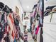 Walk-in closet featuring hanging clothes and custom built-in storage at 4915 South Rd, New Port Richey, FL 34652
