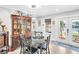 Elegant dining room featuring a glass table, modern lighting, and water views at 4915 South Rd, New Port Richey, FL 34652