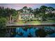 Exterior view of a two-story home with a waterfront view and palm trees at 4915 South Rd, New Port Richey, FL 34652