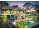 Two-story house with deck, fenced pool, landscaped backyard, and stairs to the top floor at 4915 South Rd, New Port Richey, FL 34652