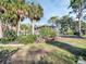 Exterior view of a home with a well-maintained lawn and mature trees at 4915 South Rd, New Port Richey, FL 34652