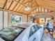 Garage interior featuring exposed beams, stained glass window and vehicle inside at 4915 South Rd, New Port Richey, FL 34652