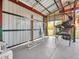 This garage has a metal ceiling, concrete floor, and large storage space at 4915 South Rd, New Port Richey, FL 34652