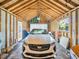 Garage interior with white Cadillac, stained glass window, and white paneled door at 4915 South Rd, New Port Richey, FL 34652