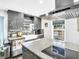 Open concept kitchen with farmhouse sink, stainless appliances, and a view to the canal at 4915 South Rd, New Port Richey, FL 34652