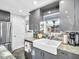 Updated kitchen with stainless steel appliances and farmhouse style sink at 4915 South Rd, New Port Richey, FL 34652