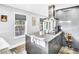 Kitchen island with granite countertops, a cooktop, and a stainless steel hood at 4915 South Rd, New Port Richey, FL 34652