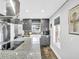 Modern kitchen featuring sleek gray cabinetry, stainless appliances, and a farmhouse sink at 4915 South Rd, New Port Richey, FL 34652