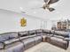 Open concept living room with large sectional sofa and view to the dining area at 4915 South Rd, New Port Richey, FL 34652