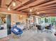 Open concept living room featuring exposed beams, several ceiling fans and tile flooring at 4915 South Rd, New Port Richey, FL 34652