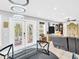 Well-lit living room with a view of the outdoor greenery through glass doors at 4915 South Rd, New Port Richey, FL 34652