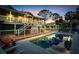 Beautiful fenced in pool at dusk, perfect for a refreshing swim and outdoor relaxation at 4915 South Rd, New Port Richey, FL 34652