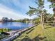 Waterfront property with a well-maintained lawn, a dock and views of the neighborhood at 4915 South Rd, New Port Richey, FL 34652