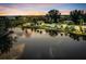 Waterfront view of colorful homes, tropical foliage, and calm waters reflecting the scenery at 4915 South Rd, New Port Richey, FL 34652