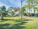 Expansive yard with lush green grass and shade trees at 4915 South Rd, New Port Richey, FL 34652