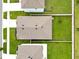Aerial view showcases the house and its neatly maintained backyard, framed by white fencing at 5474 Flint Hills Dr, Wimauma, FL 33598