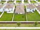 Aerial view highlights fenced backyard with lawn, showcasing the property's outdoor space at 5474 Flint Hills Dr, Wimauma, FL 33598