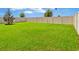 Expansive backyard featuring well-maintained lawn and fenced perimeter at 5474 Flint Hills Dr, Wimauma, FL 33598