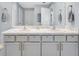 Bright bathroom featuring double vanity with marble countertop and brushed gold hardware at 5474 Flint Hills Dr, Wimauma, FL 33598