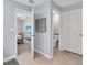 Bathroom with tiled floor leads to bedroom featuring a ceiling fan and blue walls at 5474 Flint Hills Dr, Wimauma, FL 33598