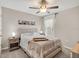 Cozy bedroom with ceiling fan, and a bed with a wooden tray and matching nightstands at 5474 Flint Hills Dr, Wimauma, FL 33598