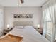 Cozy bedroom featuring a ceiling fan, and a bed with a wooden tray and matching nightstands at 5474 Flint Hills Dr, Wimauma, FL 33598