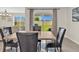 Dining area with modern table and chairs, and backyard view at 5474 Flint Hills Dr, Wimauma, FL 33598