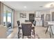 Open dining area featuring a modern table set and seamless kitchen access at 5474 Flint Hills Dr, Wimauma, FL 33598