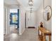 Inviting foyer with tile flooring, stylish pendant lights, and a rustic wooden console table at 5474 Flint Hills Dr, Wimauma, FL 33598