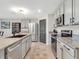 Modern kitchen with stainless steel appliances, granite countertops, and neutral cabinets at 5474 Flint Hills Dr, Wimauma, FL 33598