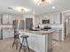 Well-equipped kitchen with a central island, stainless steel appliances, and bar stool seating at 5474 Flint Hills Dr, Wimauma, FL 33598