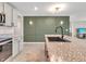 Bright kitchen with granite counters, modern fixtures, and open floor plan at 5474 Flint Hills Dr, Wimauma, FL 33598