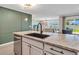 Stylish kitchen featuring granite countertops, modern fixtures, and an open layout at 5474 Flint Hills Dr, Wimauma, FL 33598