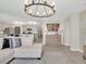 Open-concept home with a view of the eat-in kitchen with stone countertops and stainless steel appliances at 5474 Flint Hills Dr, Wimauma, FL 33598