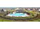 An aerial view of a community pool and outdoor lounging area at 5474 Flint Hills Dr, Wimauma, FL 33598
