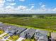 Aerial view of a residential community with lush green spaces, a serene pond, and scenic views at 8077 Tea Olive Ter, Palmetto, FL 34221
