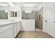 Bathroom featuring a walk-in shower with gray tiling, and double vanity with modern finishes at 8077 Tea Olive Ter, Palmetto, FL 34221