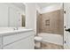 Bright bathroom with a sleek vanity, tub-shower combo, and modern fixtures at 8077 Tea Olive Ter, Palmetto, FL 34221
