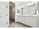 Bright bathroom featuring double vanity sinks, a large mirror, and walk-in closet at 8077 Tea Olive Ter, Palmetto, FL 34221