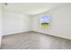 Bright, empty bedroom with tile floors and a window with views of a field at 8077 Tea Olive Ter, Palmetto, FL 34221