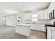 Bright kitchen with an island, stainless steel appliances, and modern white cabinetry at 8077 Tea Olive Ter, Palmetto, FL 34221