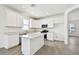 Modern kitchen featuring white cabinets, stainless steel appliances, granite countertops and tile flooring at 8077 Tea Olive Ter, Palmetto, FL 34221
