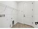 The laundry room includes shelving, tile floors, and essential hookups at 8077 Tea Olive Ter, Palmetto, FL 34221
