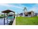 Waterfront property featuring a boat lift, tiki bar, and lush landscaping for relaxing by the canal at 108 W Saint Johns Way # 210, Apollo Beach, FL 33572