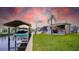 Waterfront property featuring a boat lift, tiki bar, and lush landscaping for relaxing by the canal at 108 W Saint Johns Way # 210, Apollo Beach, FL 33572