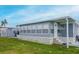 Inviting exterior with large windows, an extended awning, and a lush, green lawn at 108 W Saint Johns Way # 210, Apollo Beach, FL 33572