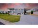 Charming home featuring a covered parking area, bench seating, and well-manicured lawn at 108 W Saint Johns Way # 210, Apollo Beach, FL 33572